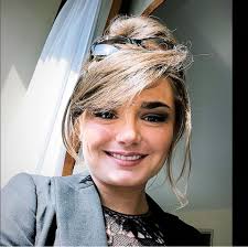 Instructor Madison Lareau beside a horse with a young rider